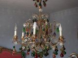 a chandelier hanging from the ceiling in a bedroom