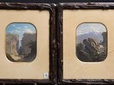 two framed paintings of a mountain scene with a man and a woman