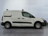 a white van parked in a parking lot on a cloudy day