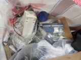 a box full of electronic equipment that is sitting on a bed