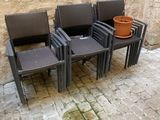 four chairs and a table with a pot on it