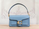 a blue handbag sitting on top of a wooden table
