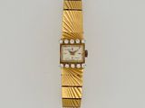 an image of a gold watch with diamonds on it
