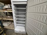 a white refrigerator that is open in a room
