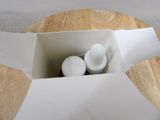 a white container with two white balls inside of it