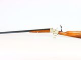 an old rifle with a wooden handle on a white background