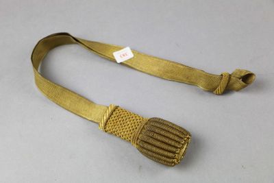 an image of a gold belt with a metal buckle on a white surface