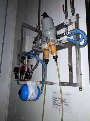 a picture of a water filtrator with a hose attached to it