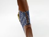blue and brown handbag with a brown handle and a blue and white pattern