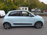 a small blue car parked in a parking lot
