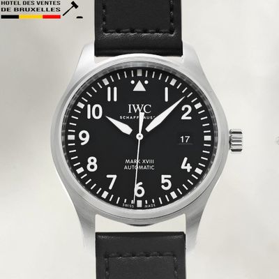 an image of a wrist watch with a black dial and black leather strap