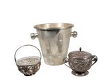 a silver ice bucket and a silver teapot on a white background