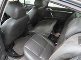 the back seats of a car with a cat in the passenger seat