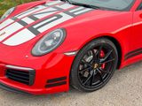 a red sports car parked on the side of the road