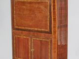 an old wooden cabinet on wheels with a marble top