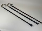 three different types of walking canes on a white surface