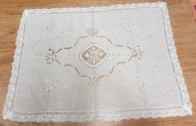 une nappe blanche à motifs posée sur une table en bois