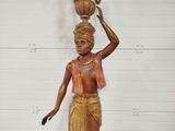 a statue of a woman holding a pot on her head