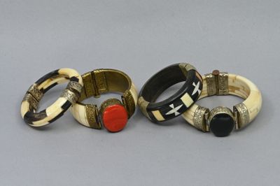 three different rings with different designs on them sitting on a table