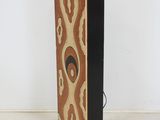 an image of a tall speaker with a black base and a pattern on it