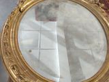 a mirror sitting on top of a table in a room
