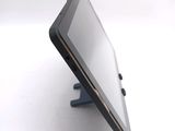 a tablet computer sitting on a stand on a white surface
