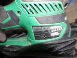 a close up of a person holding a corded sander