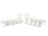a lot of glasses and cups on a white surface