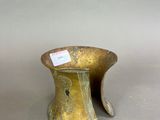 pair of antique brass vases with a label on the top