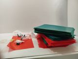 a pile of red, green, and blue paper on a counter