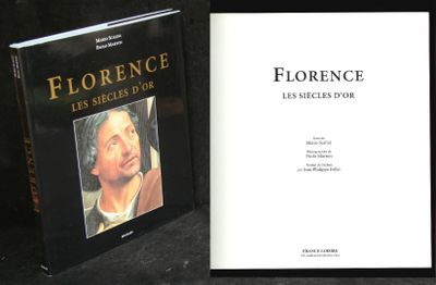 two books on a table with a black background and a picture of a man with a beard