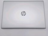 hp laptop computer sitting on top of a white table next to a keyboard