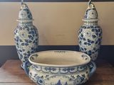 two blue and white vases and a bowl on a table