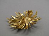 an image of a gold plated brooch with a flower on it
