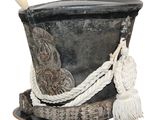 a black hat with a white rope on top of it