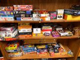 a wooden shelf with many different types of toys on it