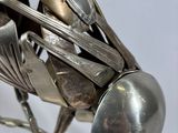 a sculpture of a bird made out of spoons and spoons