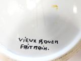 a white bowl with writing on it sitting on a table