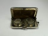 a silver case with two silver knobs inside of it