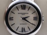 a silver wrist watch with roman numerals on it