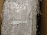 a cardboard box filled with plastic wrap and a piece of luggage