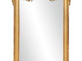 a gold framed mirror with a decorative design on it