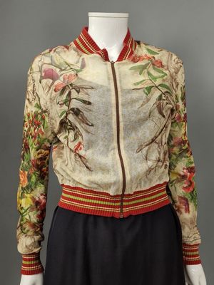 an image of a mannequin wearing a floral jacket and skirt