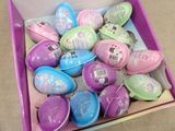 a pink box filled with lots of colorful easter eggs