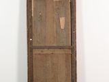 an old wooden door with a bird nest on top of it