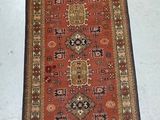 rug on the floor is red and tan with a pattern