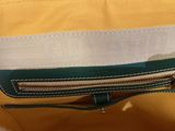 the inside of a yellow and white bag with a zipper
