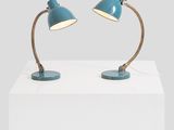 a pair of blue desk lamps on a white table