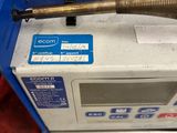 someone is holding a baseball bat on top of a machine