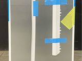an image of a refrigerator with tape taped around it